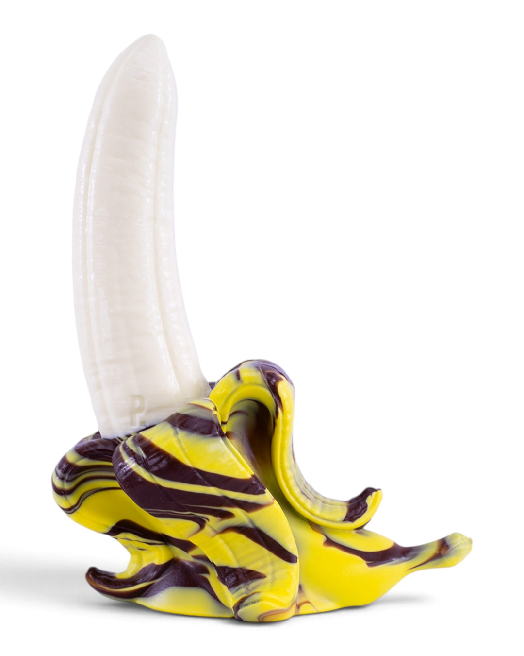 Angled view of Phreak’s Banana silicone toy with a curved cream-white centre and curled yellow and brown marbled peel on a white background.