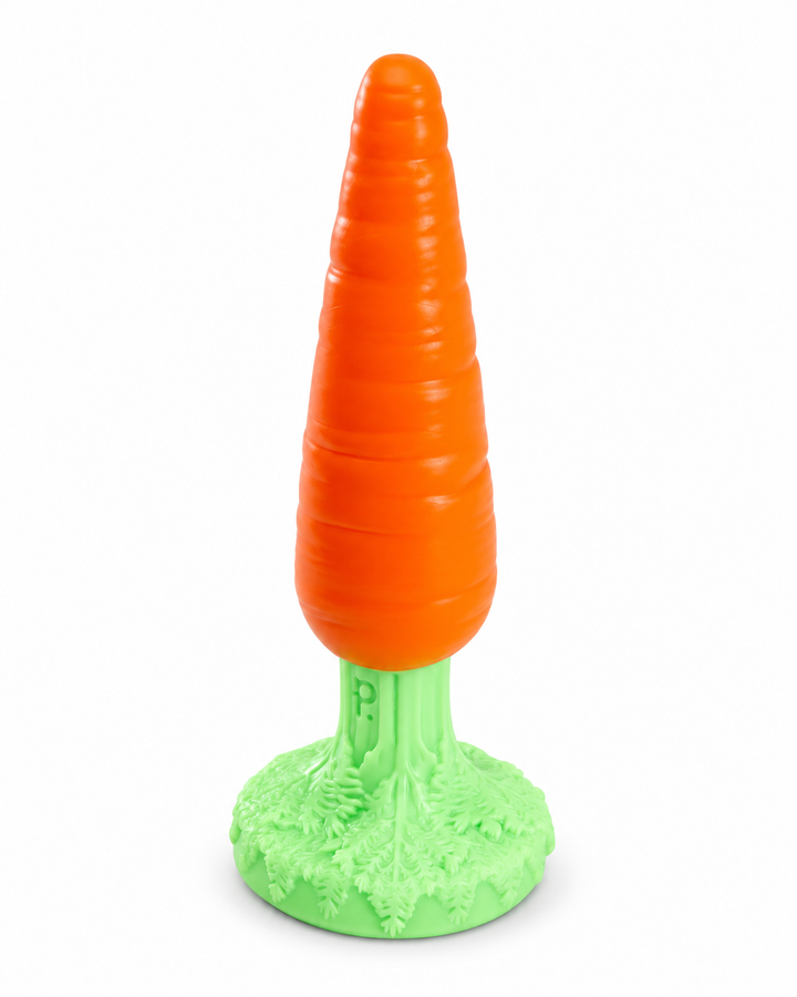 Phreak’s orange Carrot silicone toy with subtle surface grooves and a pale green leafy base on a white background.