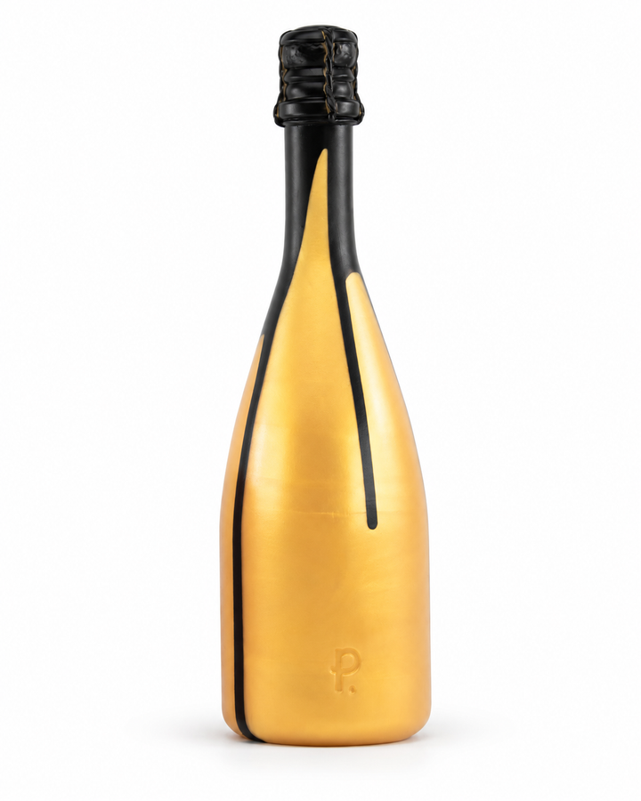 Gold silicone champagne bottle toy with black drips, a moulded cork top and Phreak logo, standing upright on white with a soft shadow.