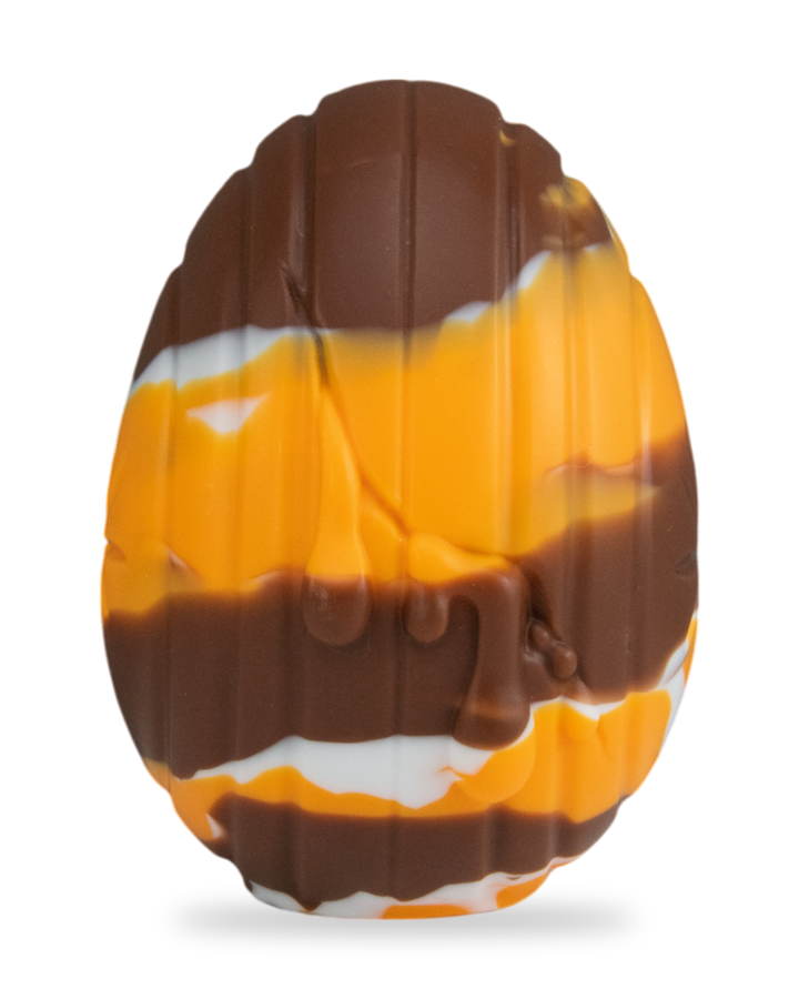 brown, orange and white Cream Egg, showing vertical grooves and moulded drips.