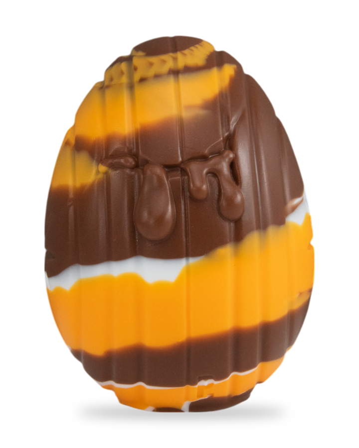 brown, orange and white Cream Egg, showing vertical grooves and moulded drips.