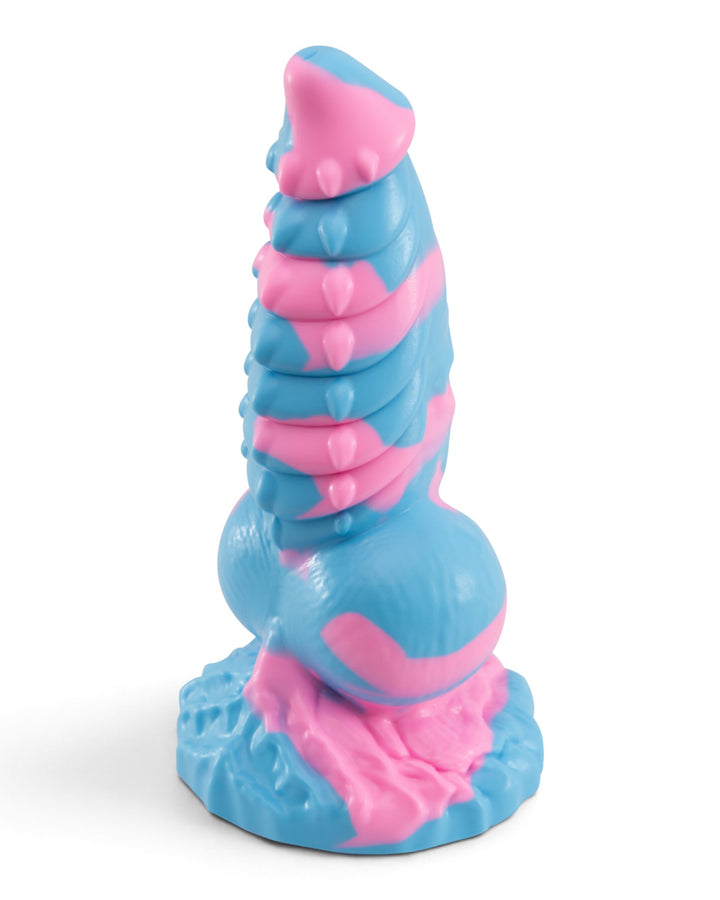 Three-quarter view of Phreak’s Dovah silicone toy in pink and blue, showing dragon-inspired ridges and a textured base.