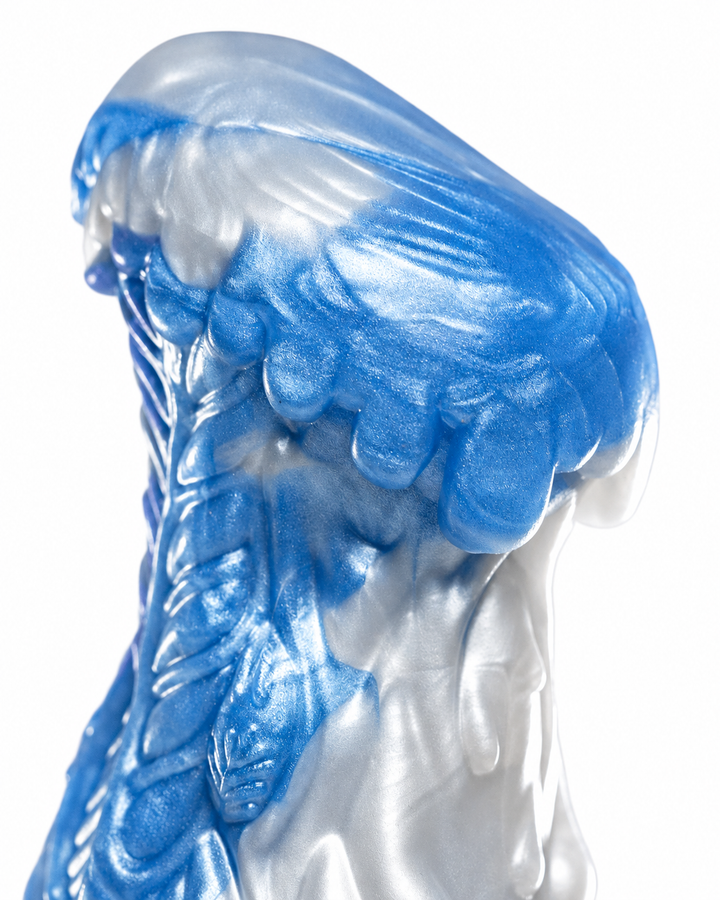 Close-up of Everest’s rounded tip with overlapping sculpted details and shimmering blue and silver marbling.