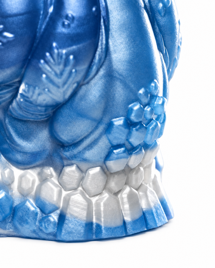 Close-up of Everest’s flared base showing faceted ice-like textures in metallic blue and silver.