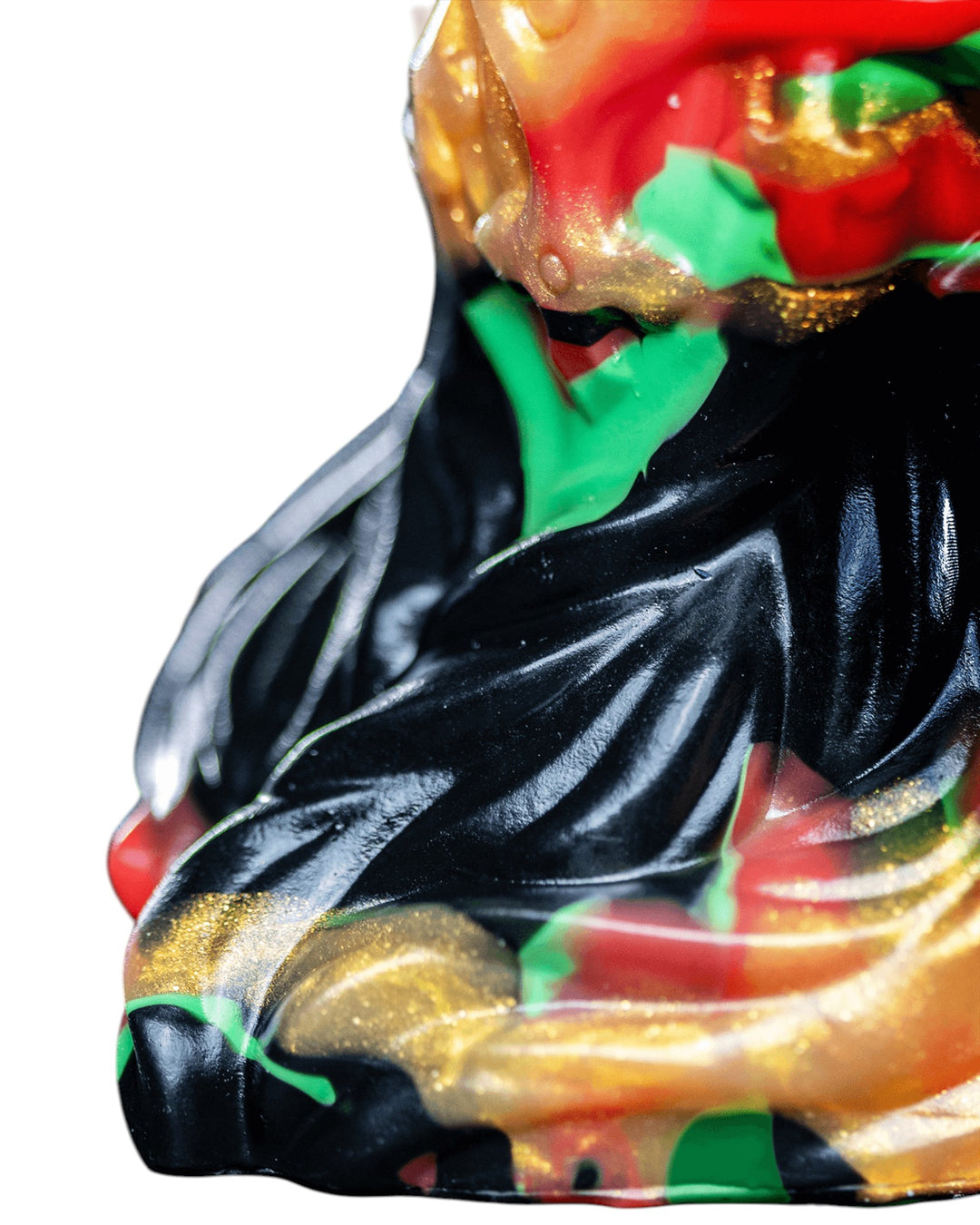 Close-up of Krampus’s flared base, showing flowing black ridges bordered by red, green and metallic gold marbling.