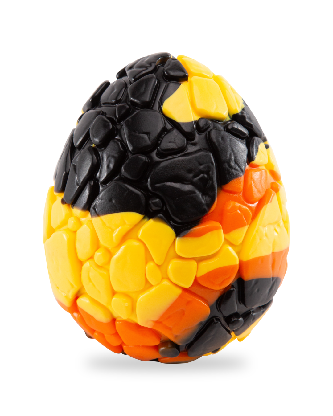 Black, yellow and orange Lava Egg silicone sculpture with raised rocky texture on a white background.