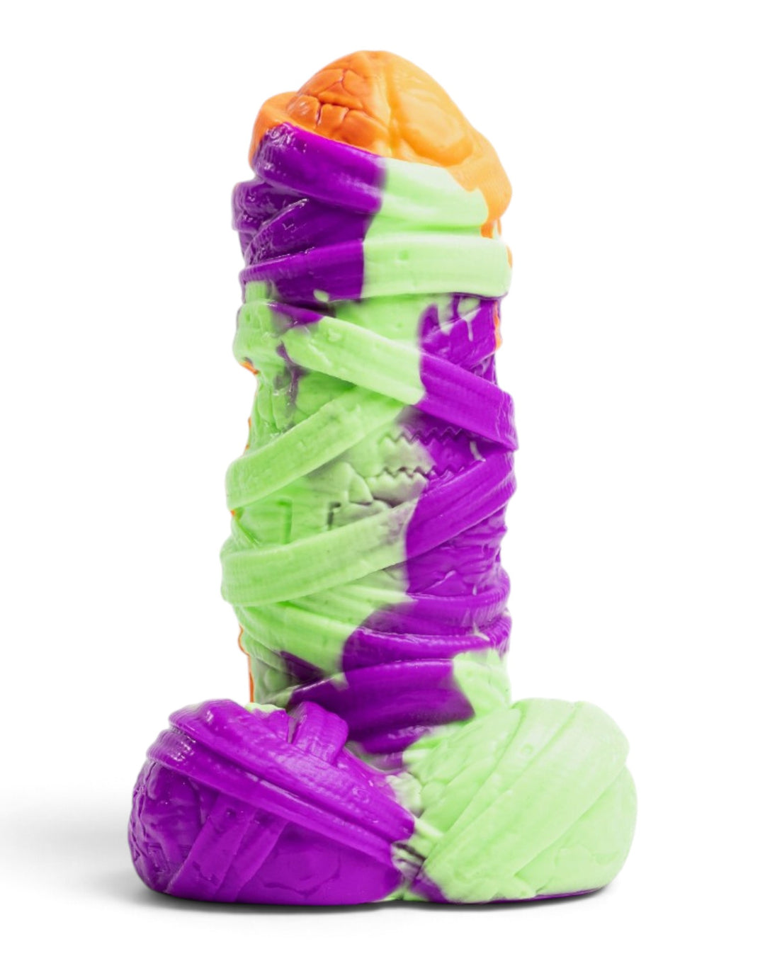 Three-quarter view of Phreak’s Mummy silicone toy in purple, pale green and orange, with raised bandages and a sculpted base.