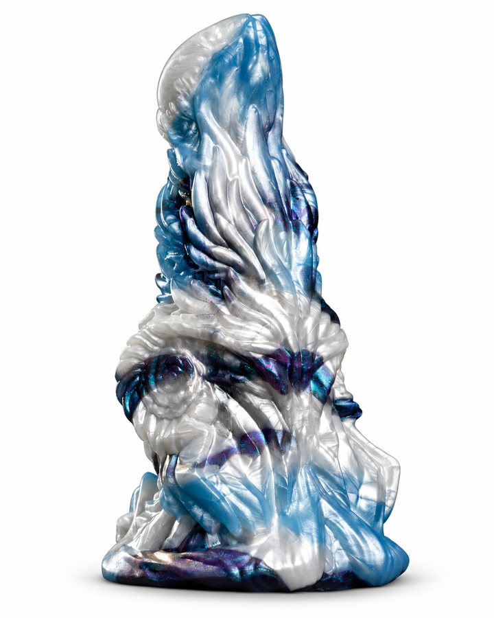 Angled view of Okami in pearlescent white, ice blue and iridescent purple, showing sculpted dragon details on white.