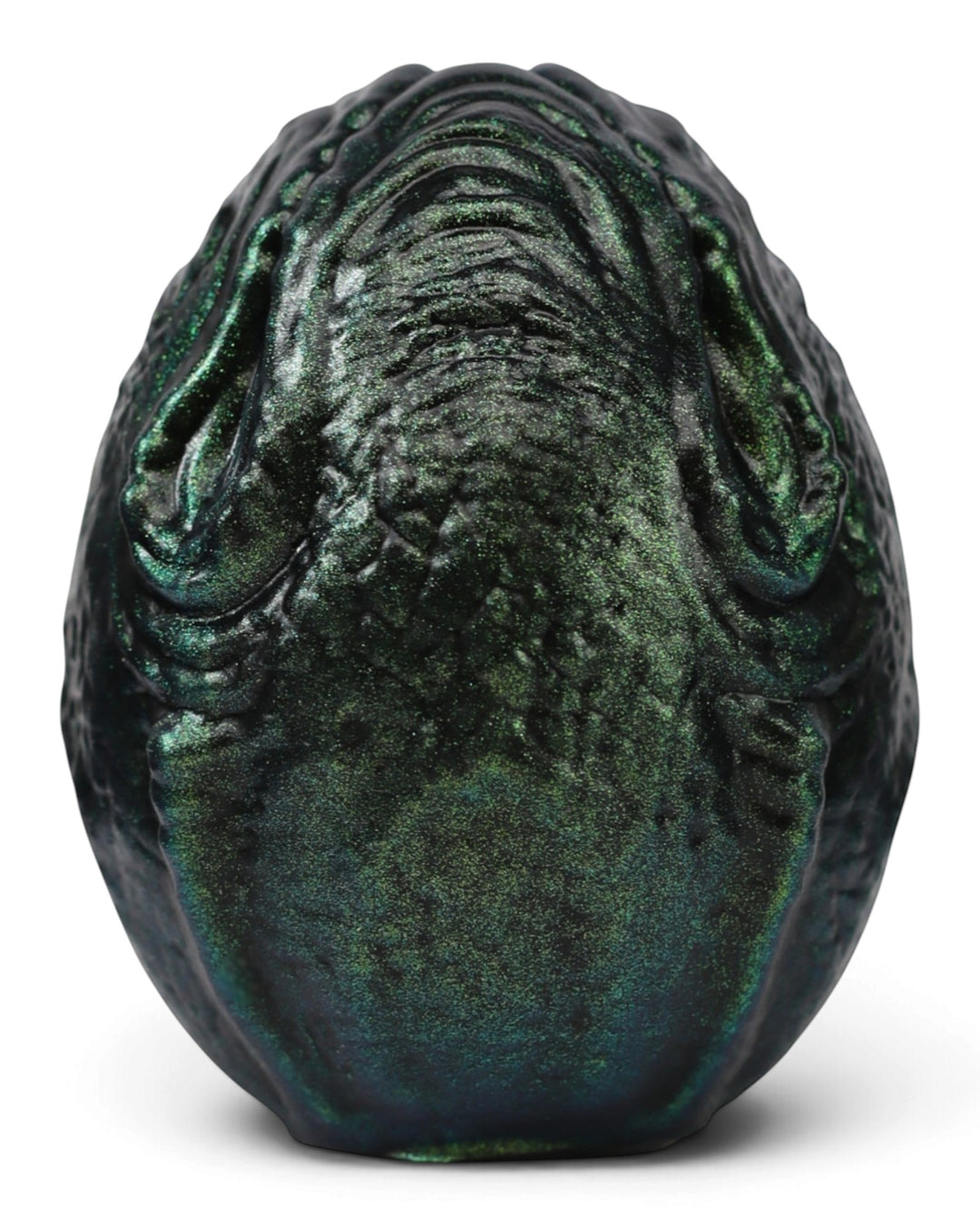 Weaver’s Ovomorph silicone egg in shimmering dark green and black, showing raised organic ridges on a white background.